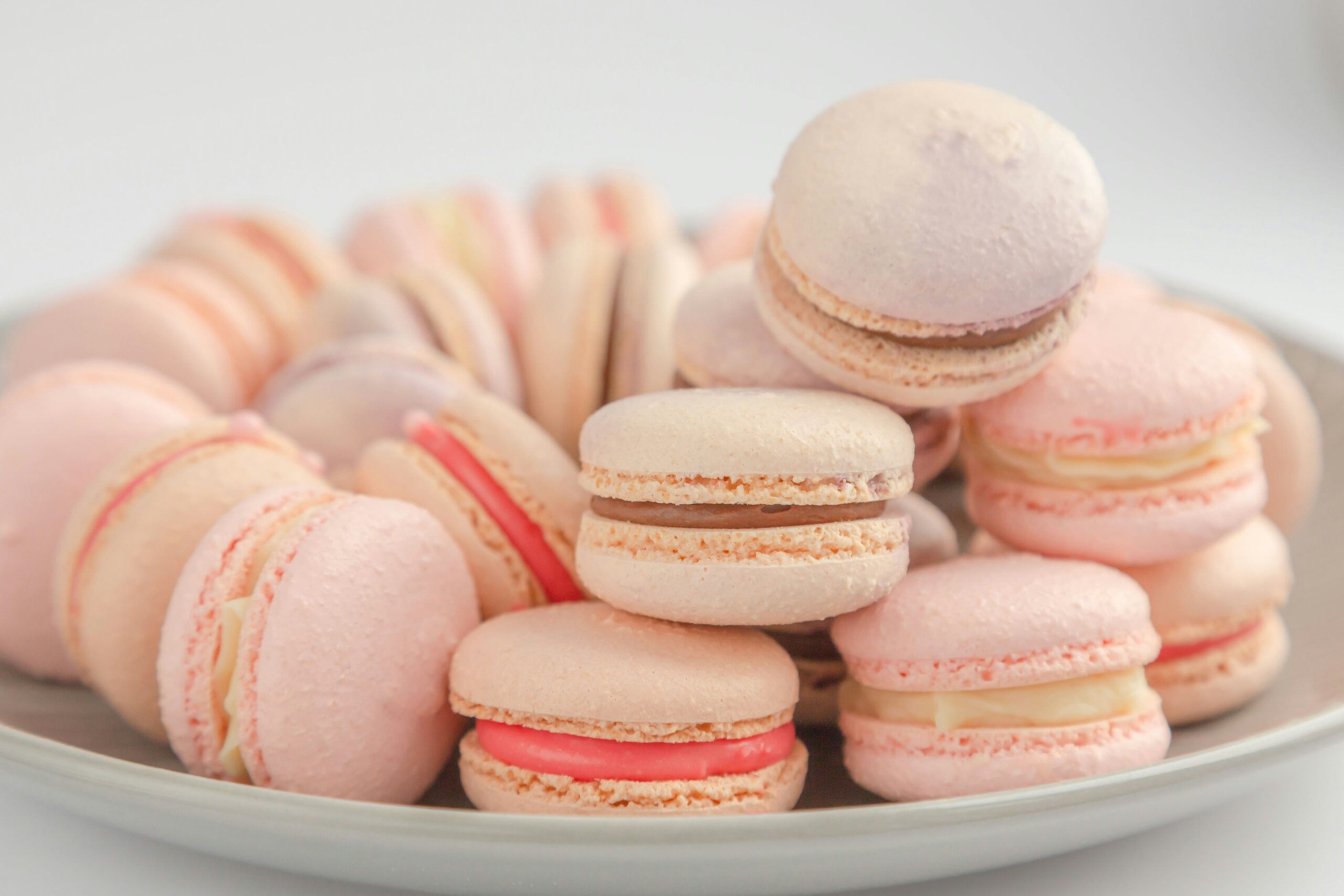 a plate of pink macarons