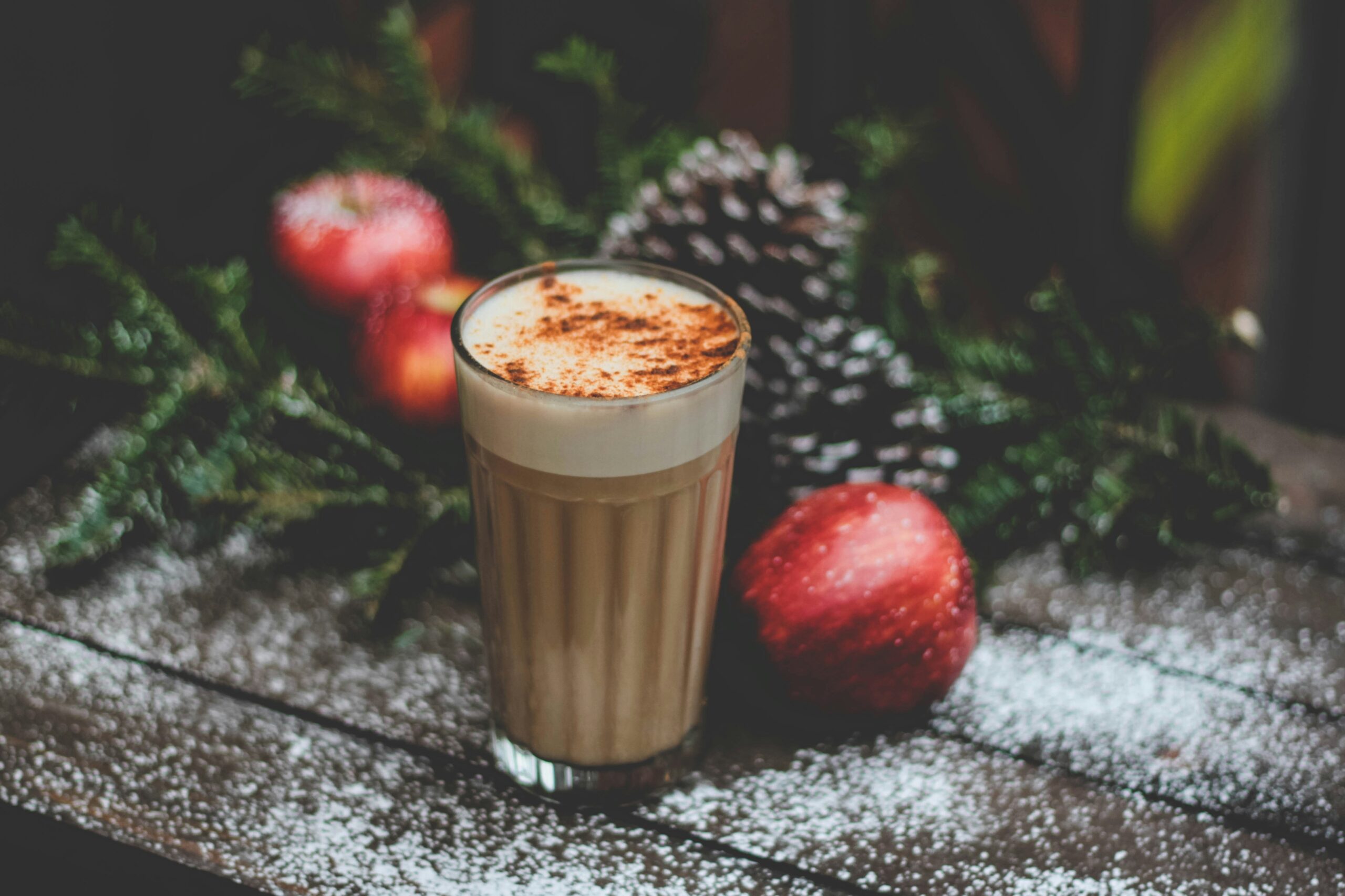 warm and cozy looking winter hot chocolate sits on a festive table