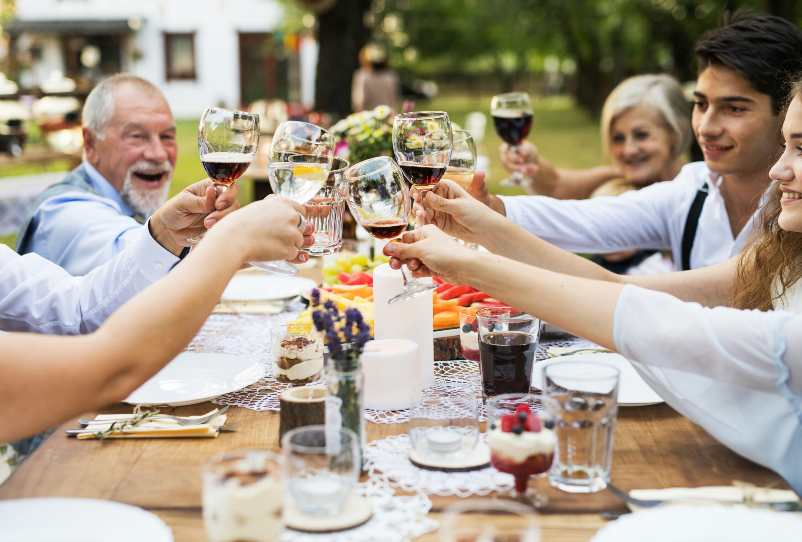 wedding guests clink glasses at a reception